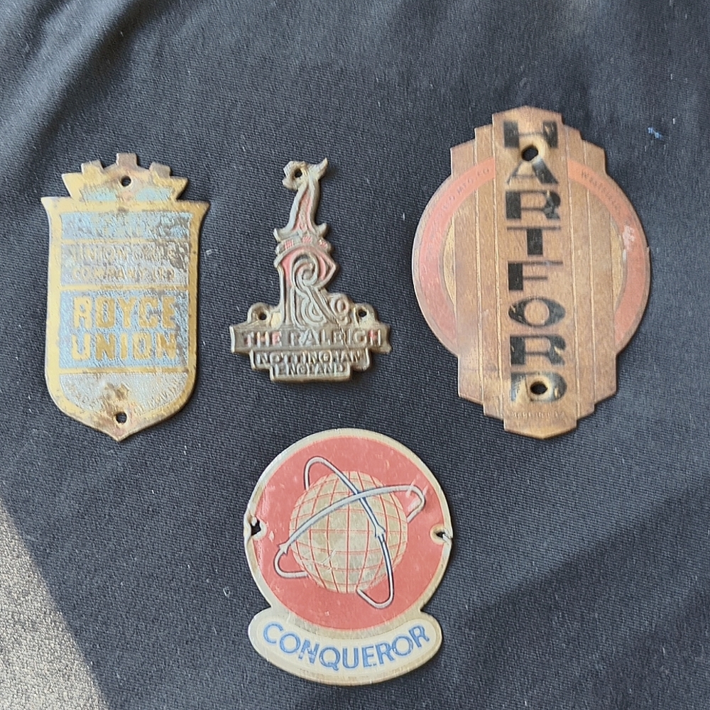 Lot of vintage bicycle head badge emblems.